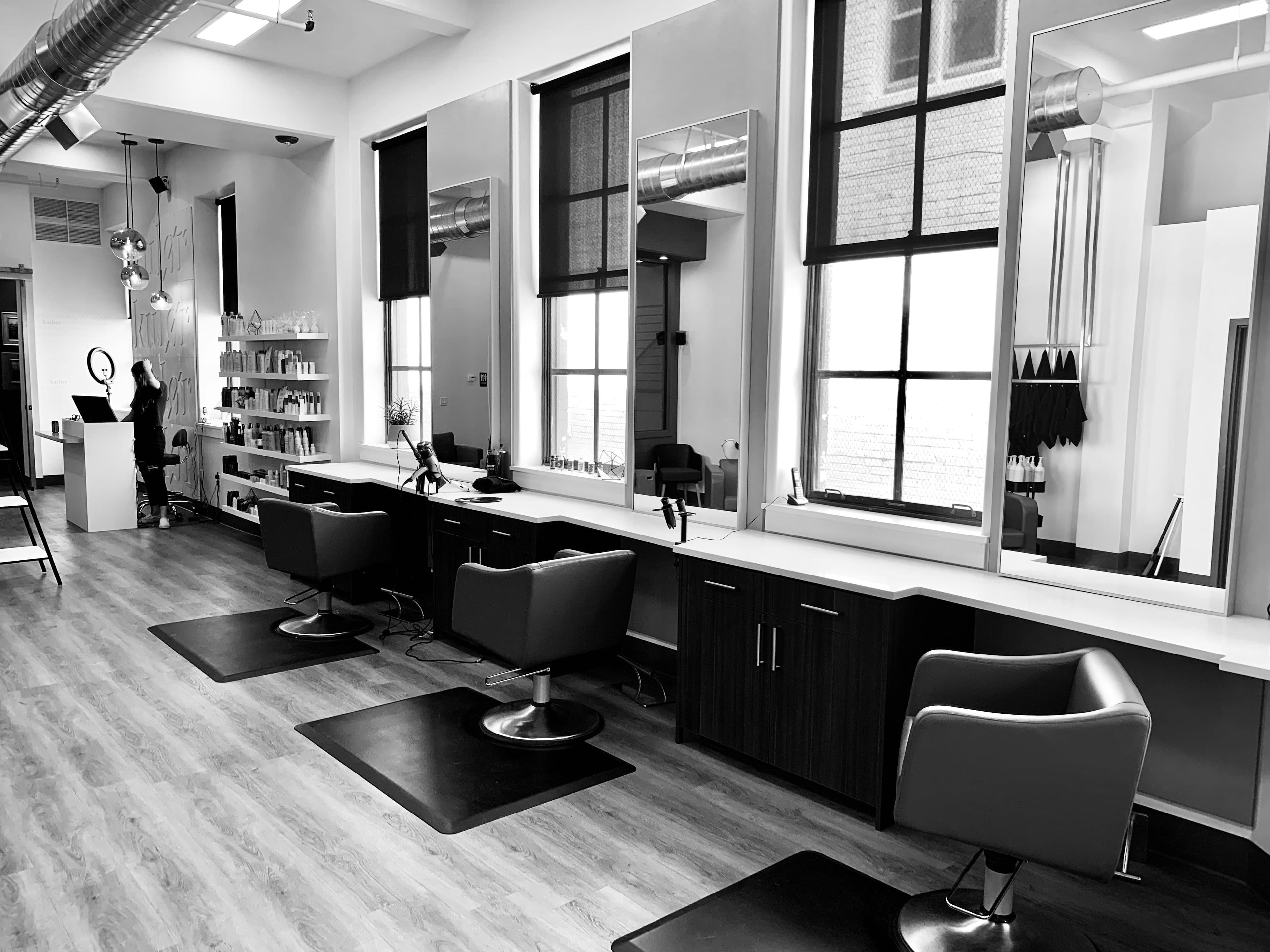 Hairdresser styling a client at a modern salon