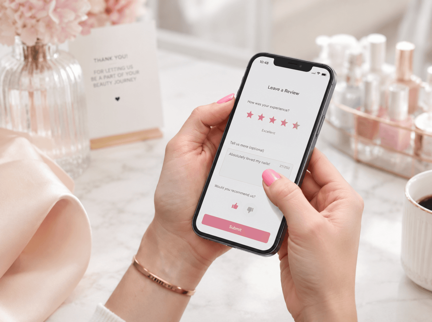 A client leaving a five-star review on her phone after a nail appointment